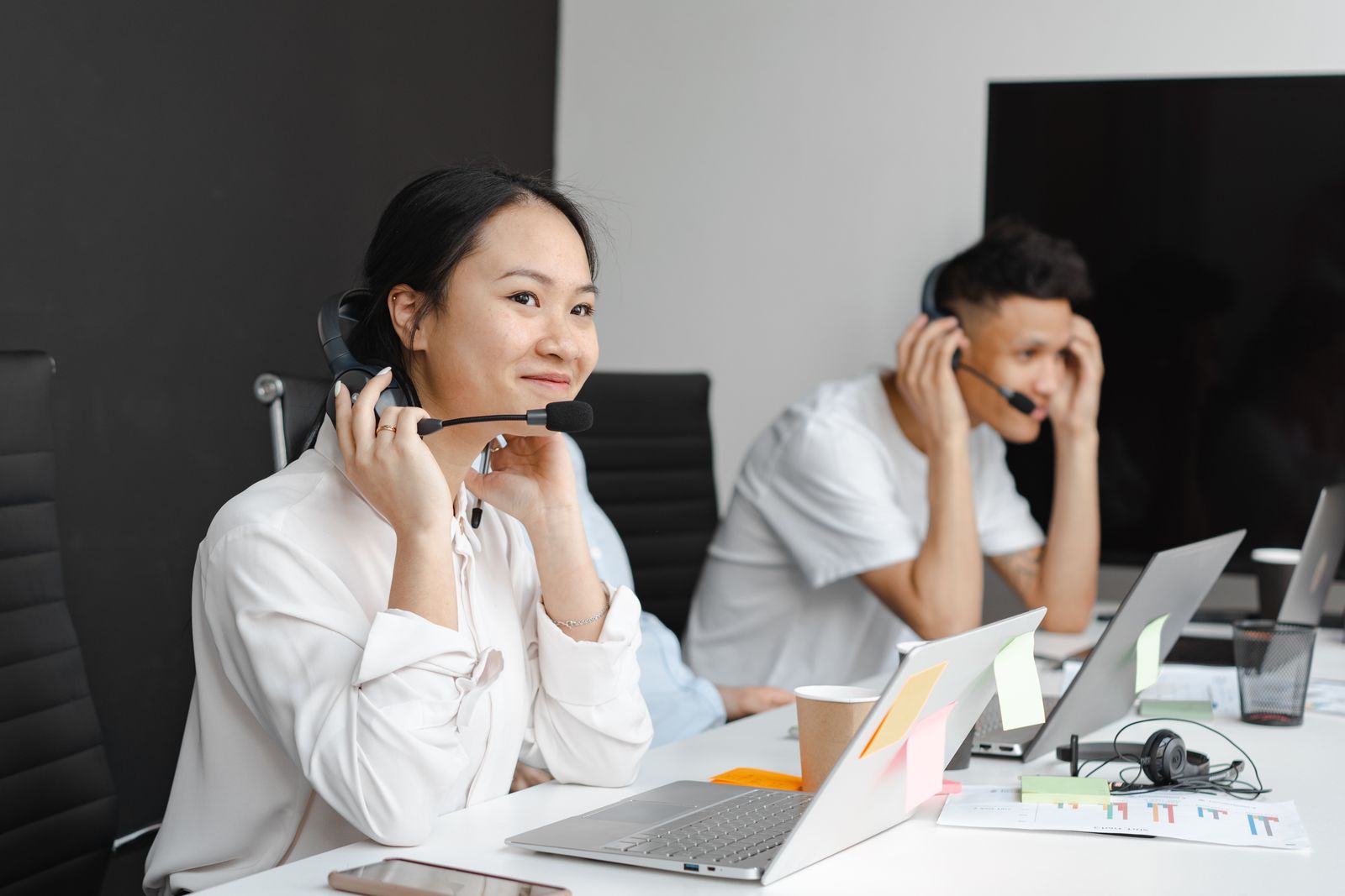 Asesora de TRAZZA atendiendo a un cliente con diadema y computadora